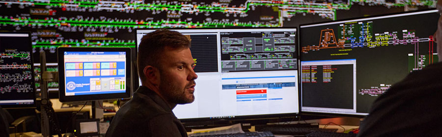 Network Control Officer viewing train control screens